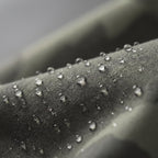 Macro of the tightly woven shell fabric with water beading on the surface