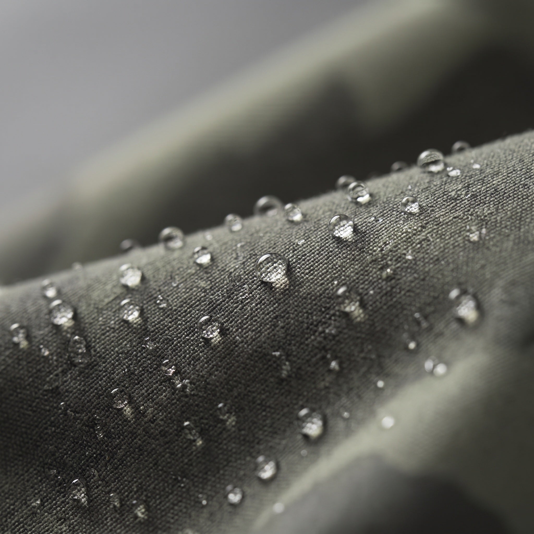Macro of the tightly woven shell fabric with water beading on the surface