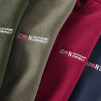 Close-up of the chest badge and fleece face across three colourways