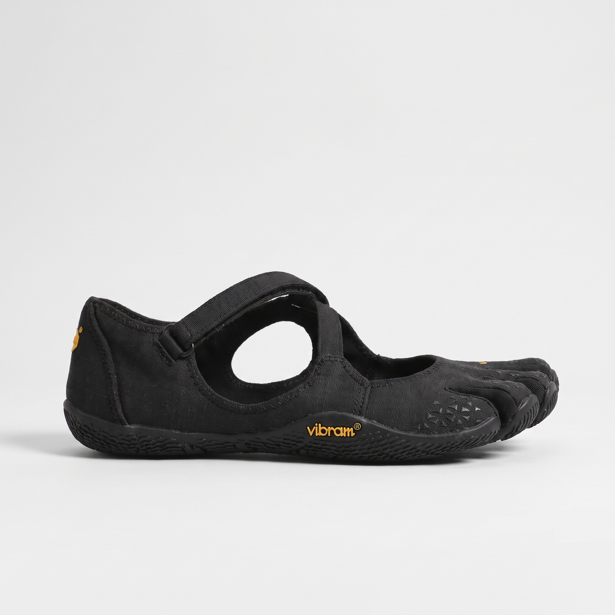 Side profile of the black five toe barefoot shoe showing the cut-out and strap