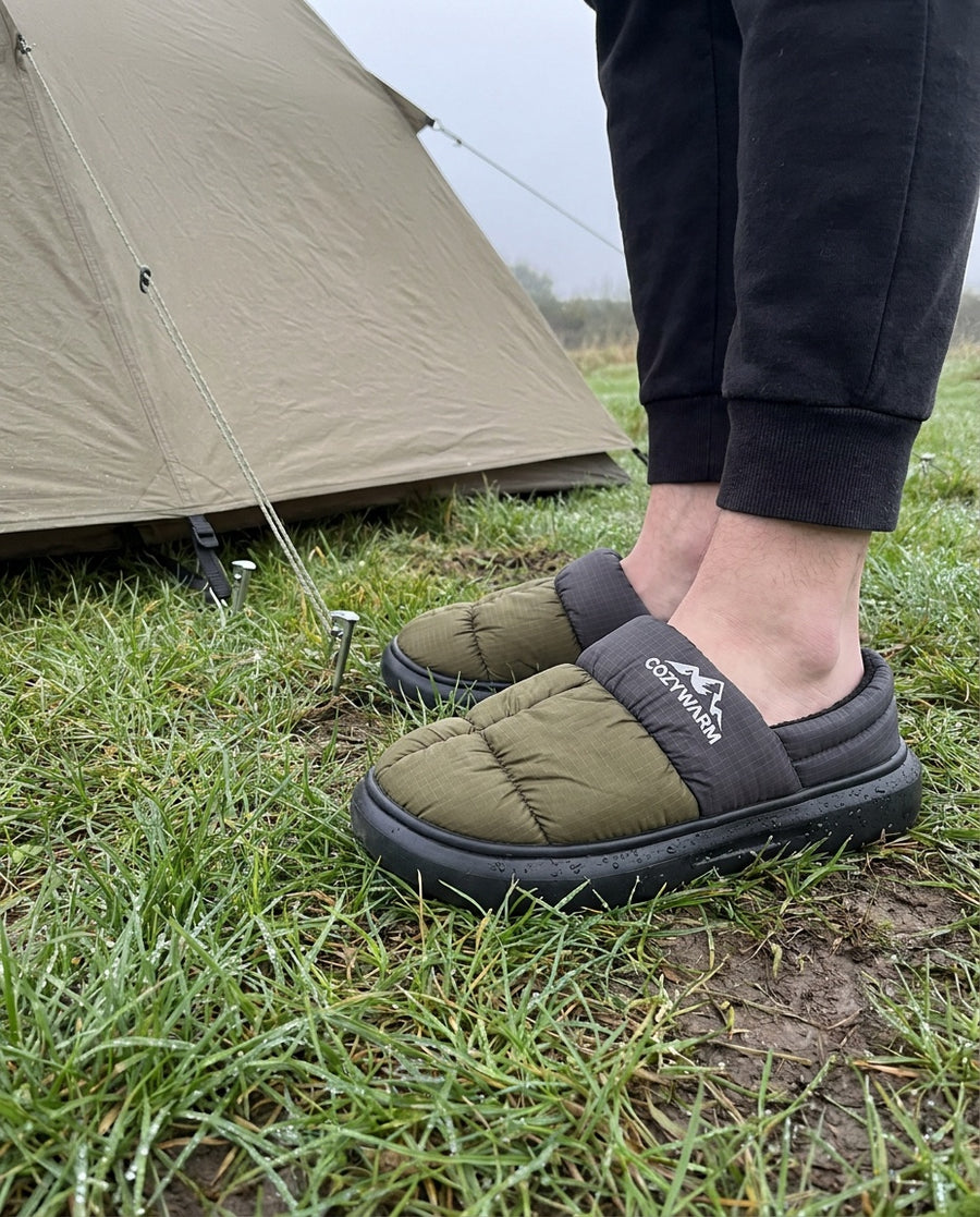 Terrabound Camp Slippers worn without socks on wet grass beside a tent