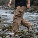 Wide-leg movement crossing a rocky riverbank