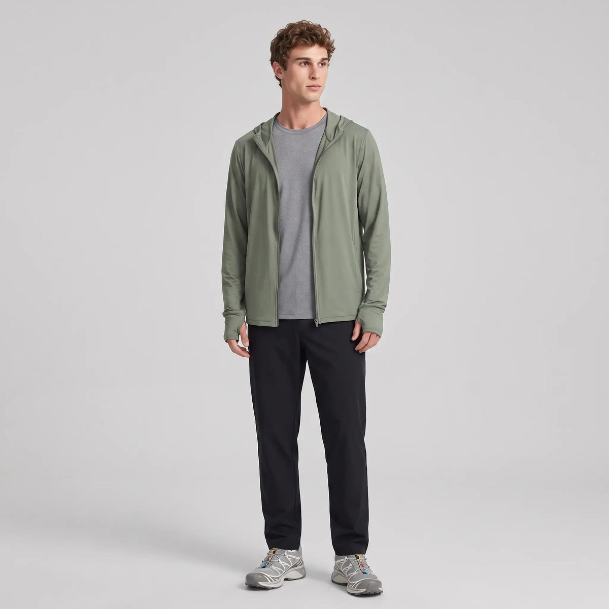 Man wearing the army green full-zip sun hoodie, full body