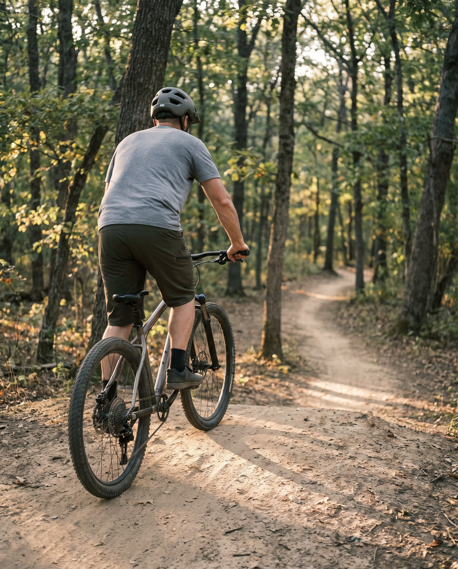 Mountain biker in baggy shorts on a woodland trail