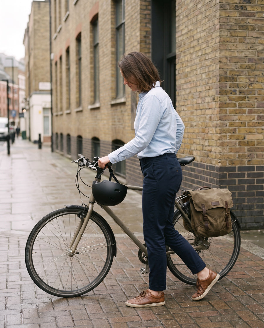 Commuter arriving at work by bike in her everyday clothes