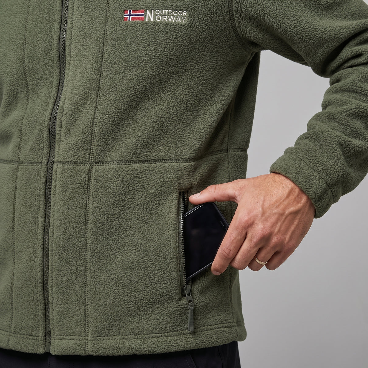 A phone going into the zipped hip pocket of the fleece jacket
