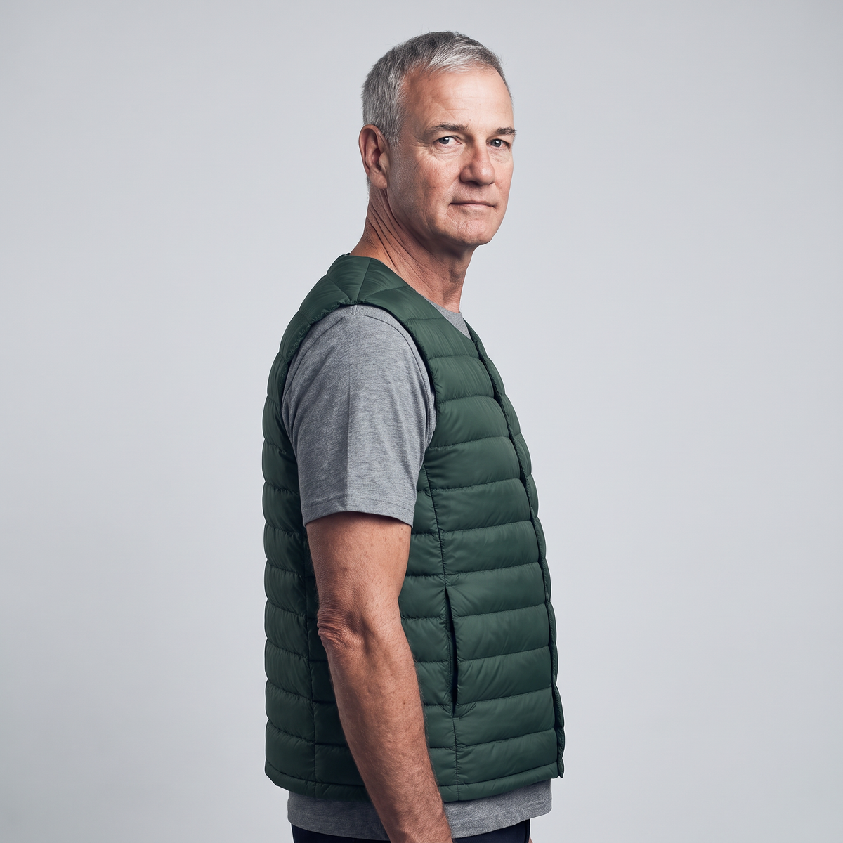 Men's Terrabound down gilet in Dark Green, three-quarter side view