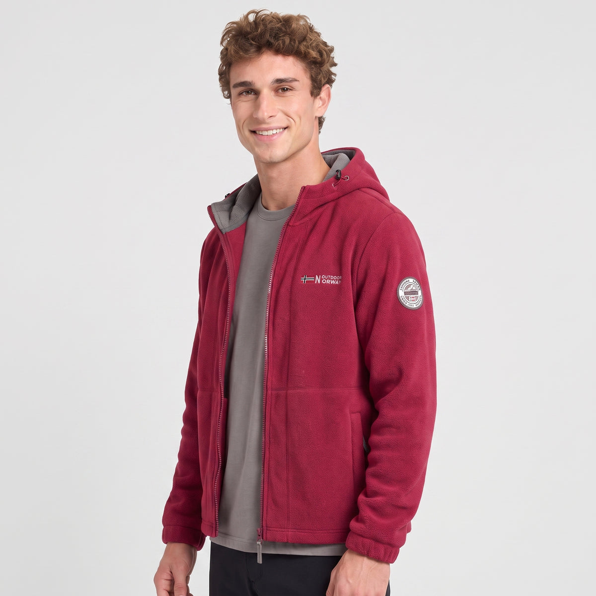 Men's red windproof fleece jacket worn, three-quarter view