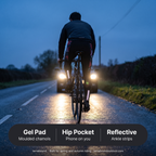 Ankle reflective strips catching car headlights on a wet road at dusk