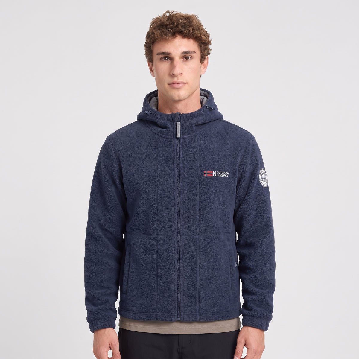 Men's navy blue windproof fleece jacket worn zipped up, front view
