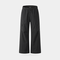 Women's wide leg walking trousers in black, front view, showing the elasticated drawcord waist and two diagonal zip thigh pockets