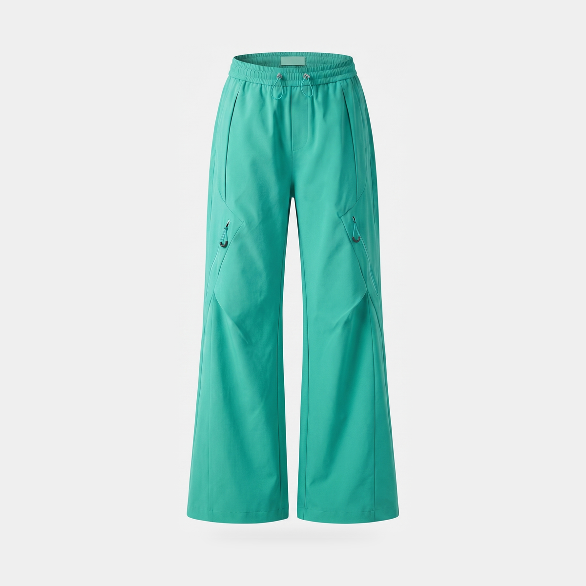 Women's wide leg walking trousers in turquoise, front view, showing the diagonal zip pockets with cord pull loops