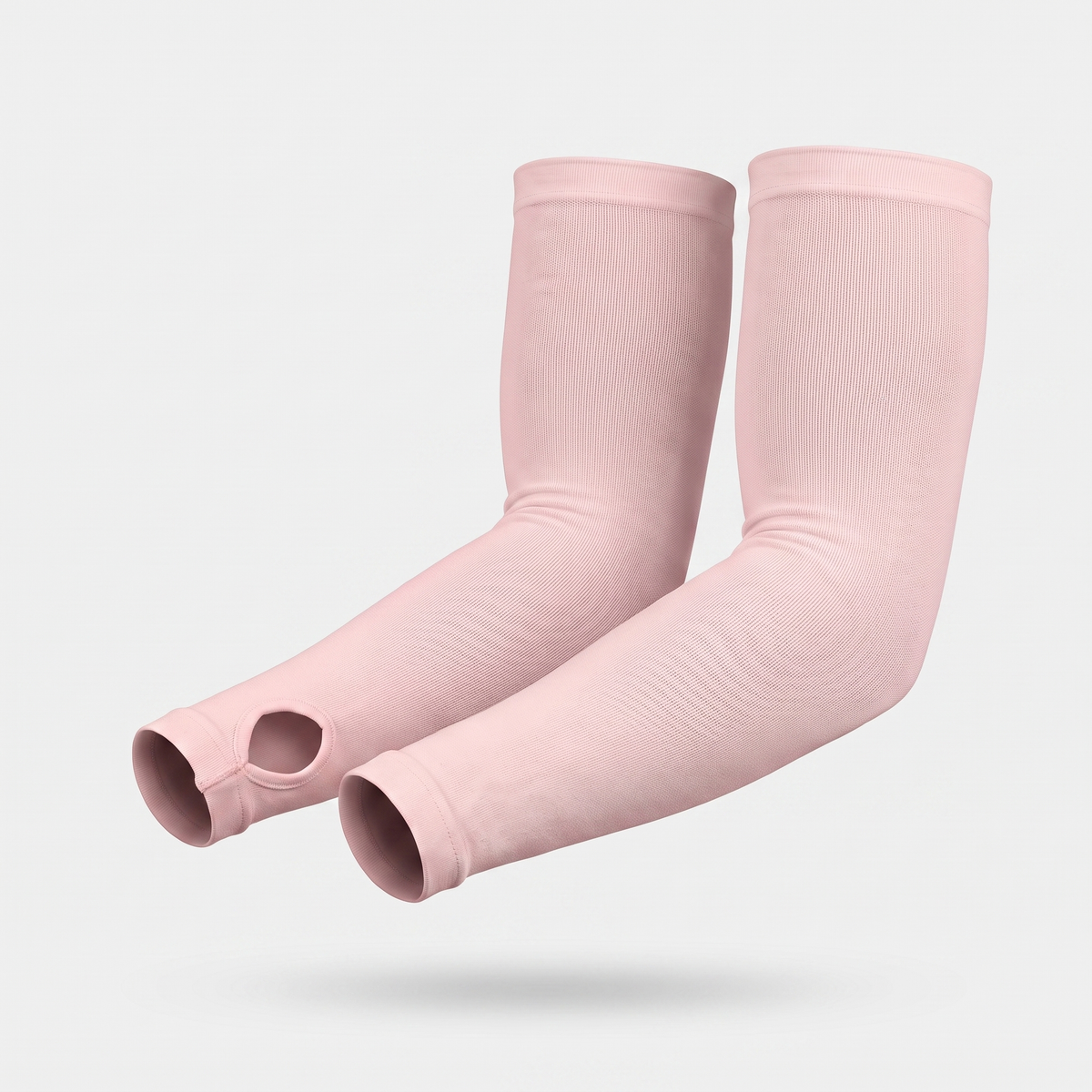 Blush Pink thumb loop UPF 50+ sun sleeves shown on a bent arm, pair