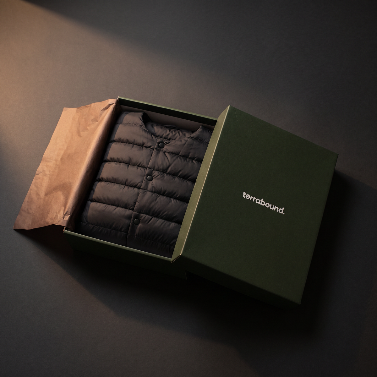 Terrabound Men's Down Jacket in Black folded in minimal packaging
