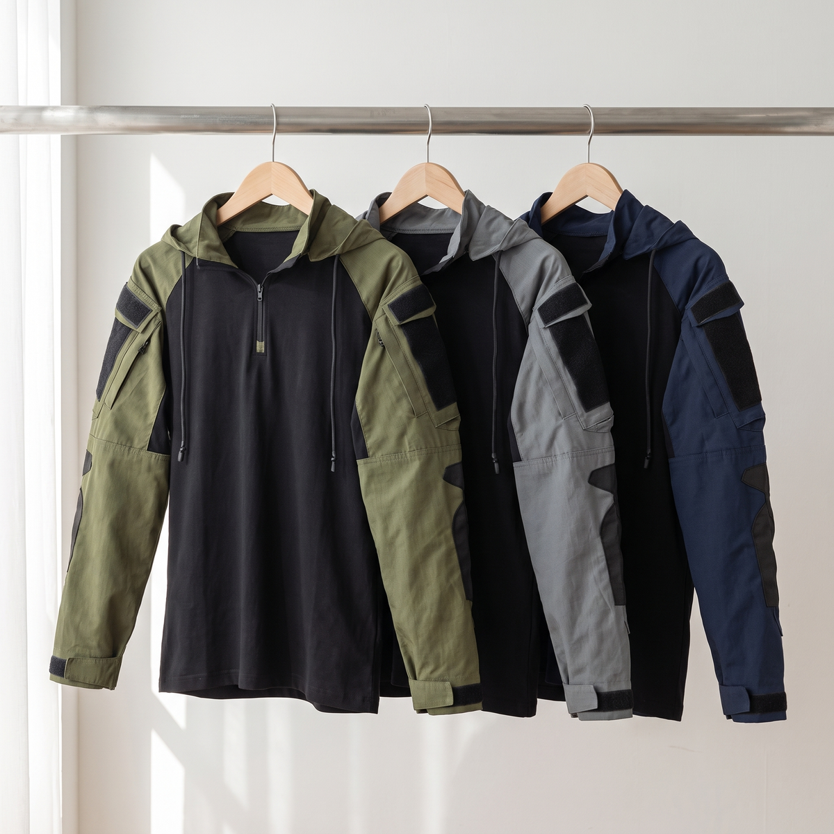 Tactical hoodie in Green, Grey and Navy Blue on a rail