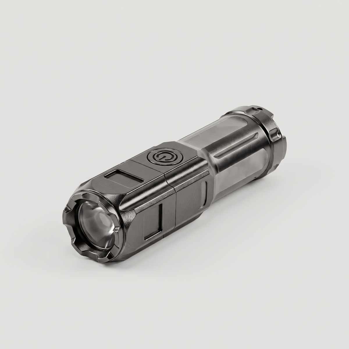 Small rechargeable torch at an angle showing the power button and zoom head