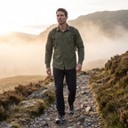 Man walking a misty Lake District path in the green hiking shirt
