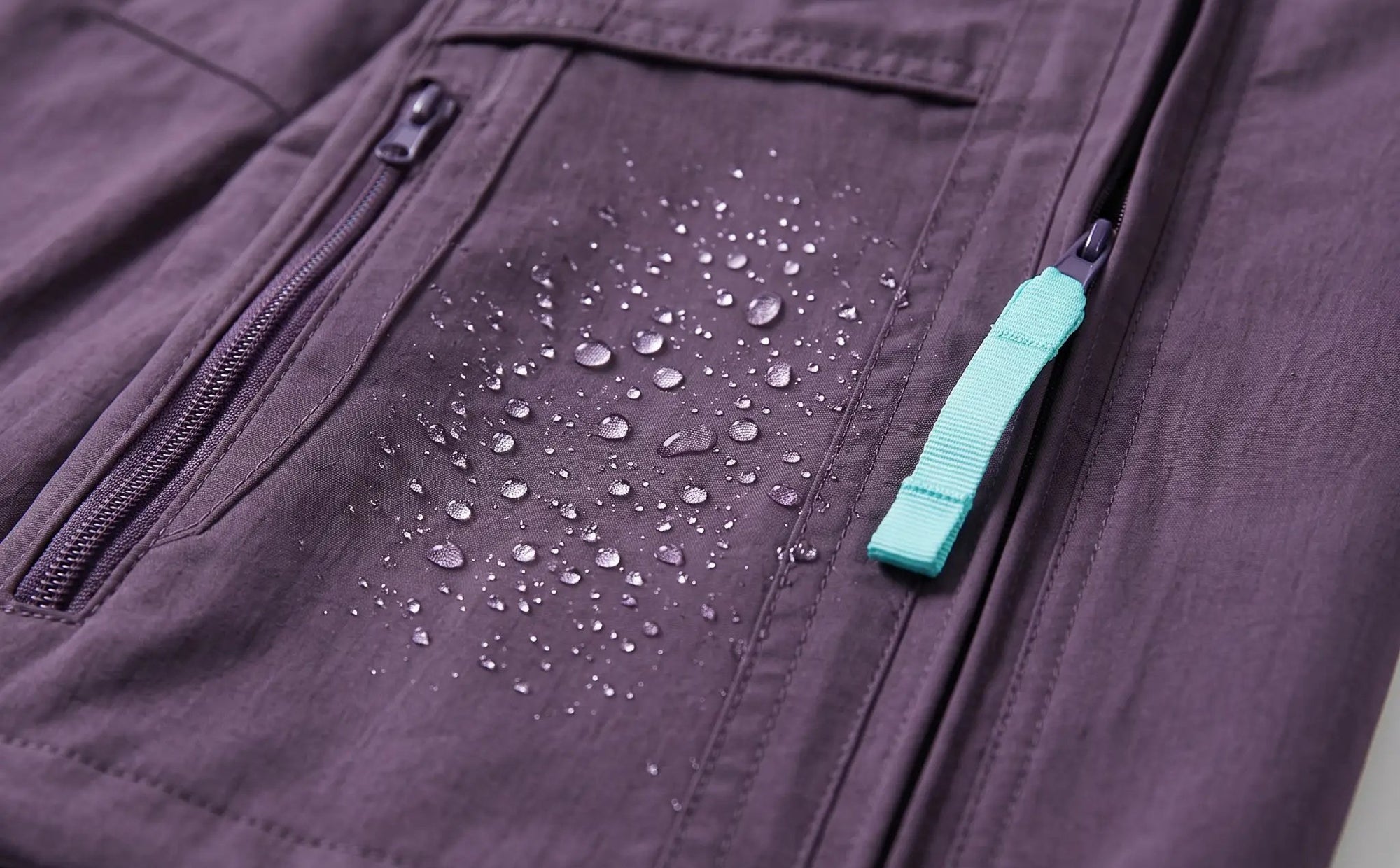 Water beading on the purple softshell face of the Terrabound wide-leg Hiking Trousers, zip pocket and side-seam zip in view
