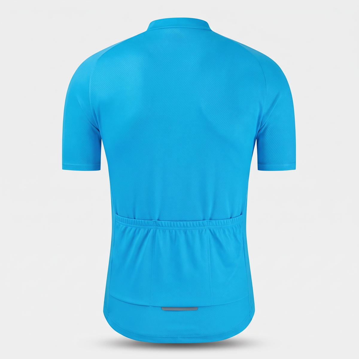 Cycling jersey back view showing the three open rear pockets and reflective hem tab