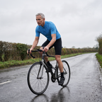 Rider on a quiet English country lane wearing the solid colour cycling jersey