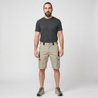 Man wearing the Khaki knee length cargo shorts, full length studio shot