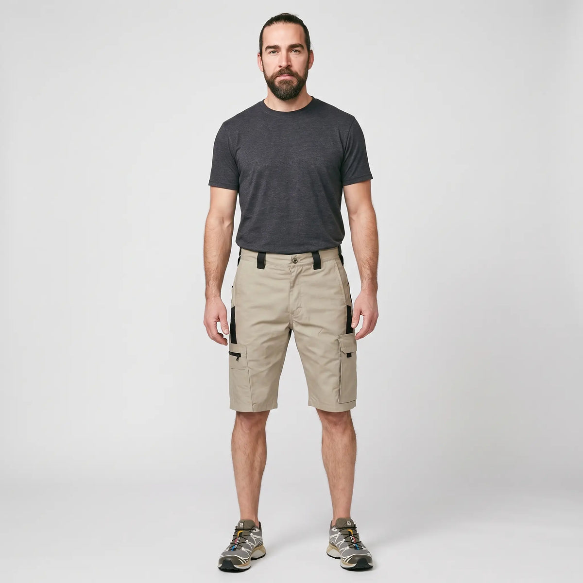 Man wearing the Khaki knee length cargo shorts, full length studio shot