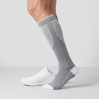 Crew height on the leg beside a plain training shoe, cuff below the knee