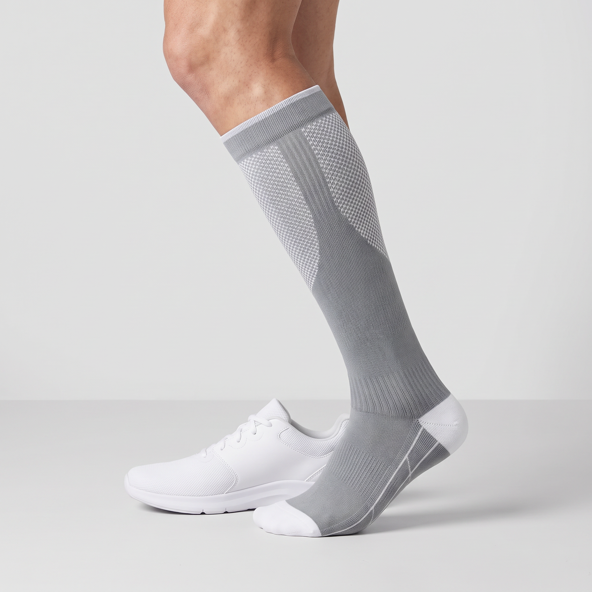Crew height on the leg beside a plain training shoe, cuff below the knee