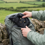 Hands folding the Terrabound men's boonie hat flat into a rucksack