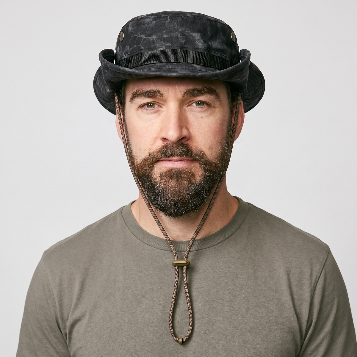 Man wearing the Terrabound men's boonie hat in black python print, front view with chin cord