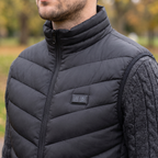 Close-up of the stand-up collar of the Terrabound men's padded gilet zipped to the top