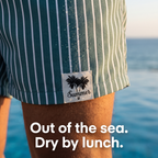 Men's striped swim shorts - woven palm tree label close-up