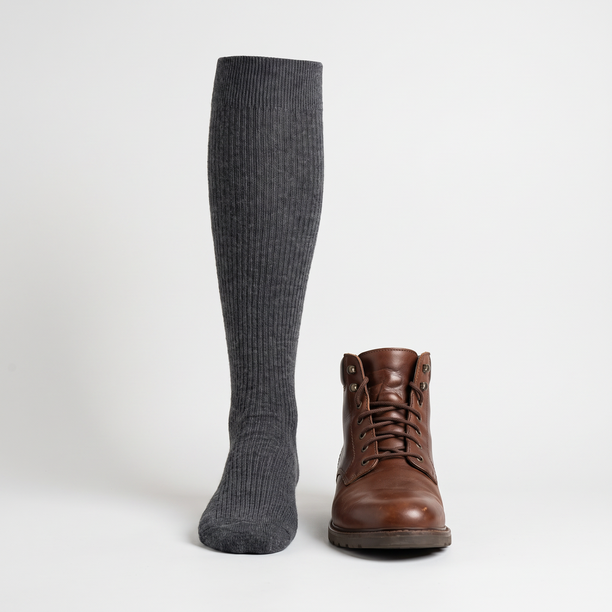 Knee high sock beside a walking boot to show the height