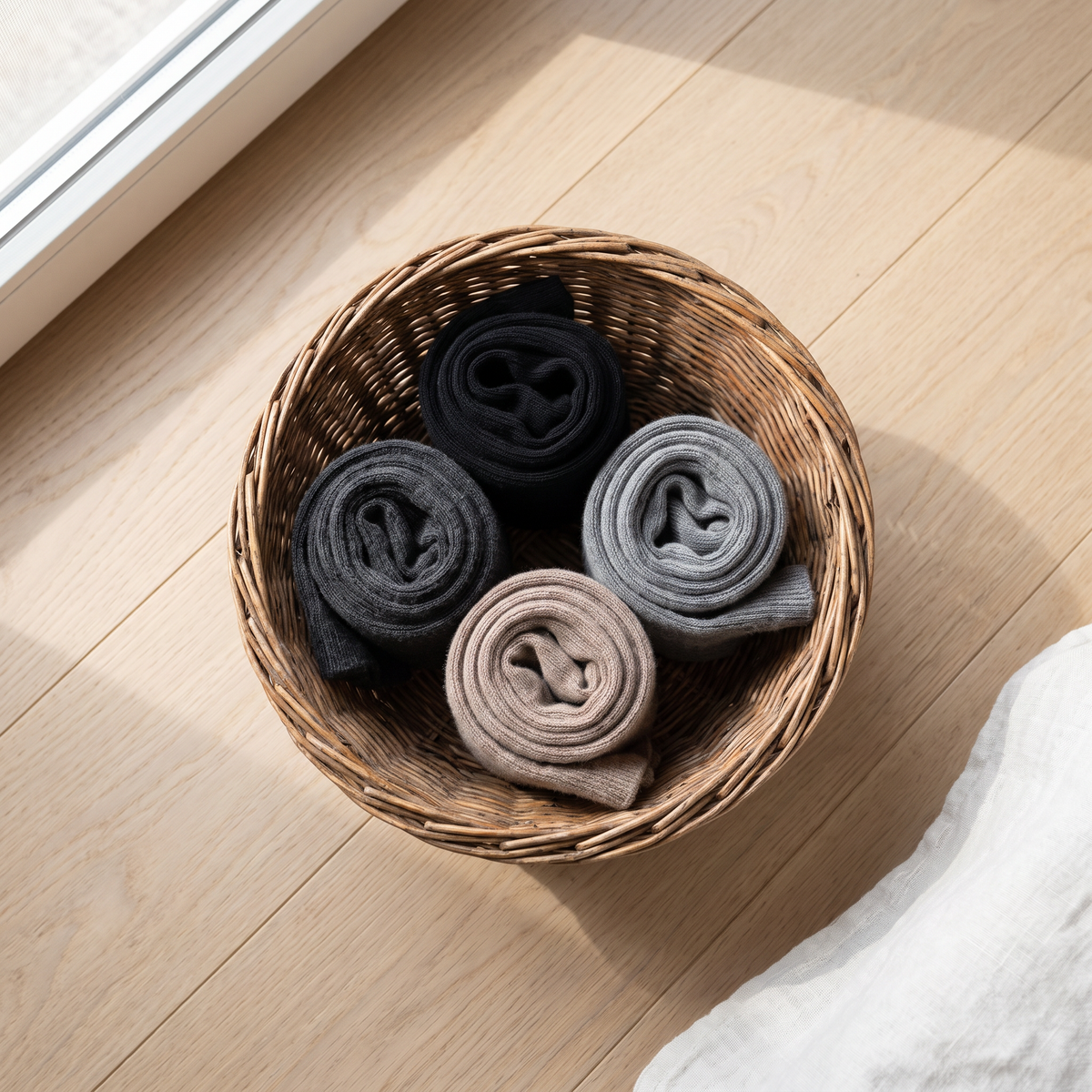 All four colours of merino wool knee high socks in a basket