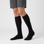Man wearing black merino wool knee high socks with walking shorts