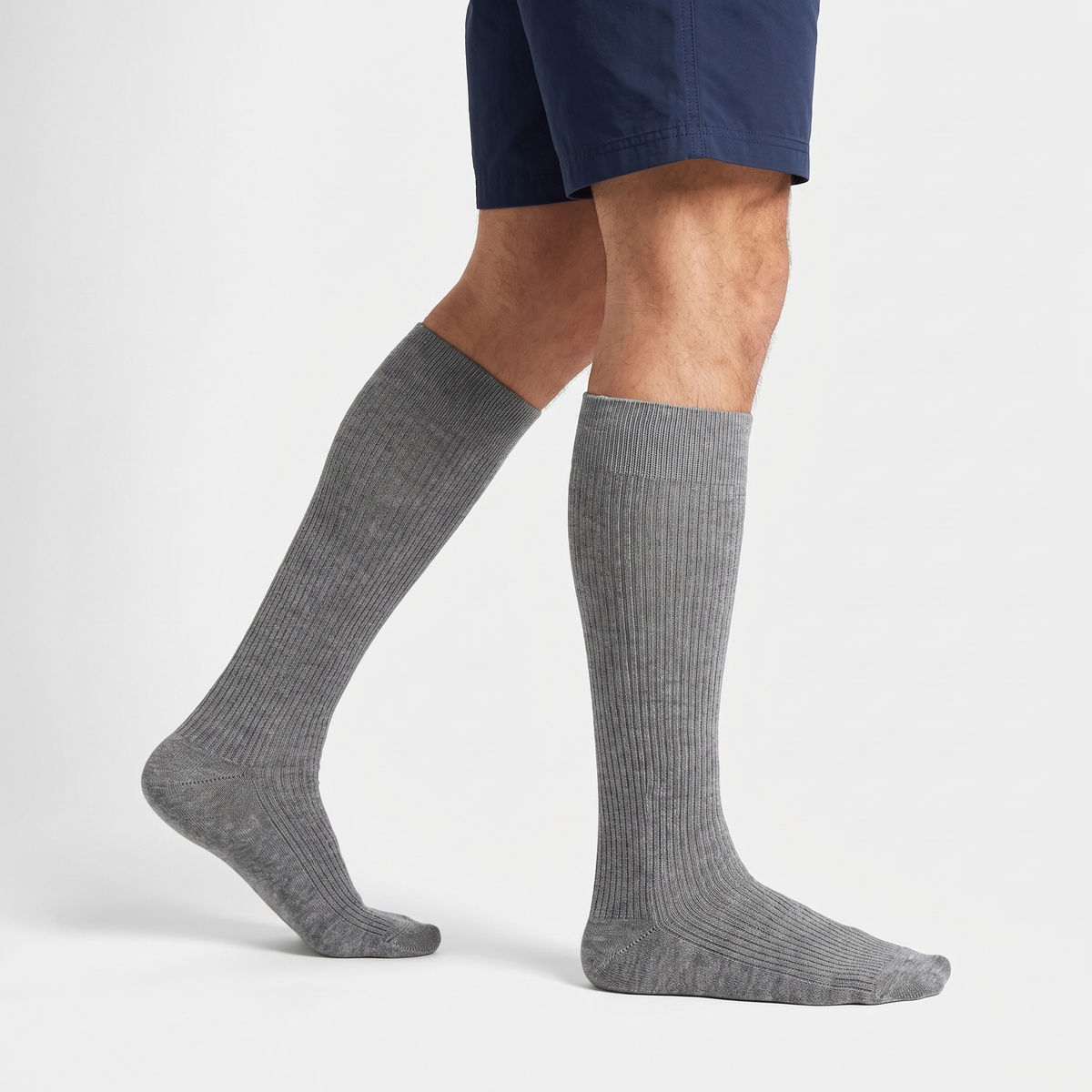 Man wearing light grey merino wool knee high socks with walking shorts