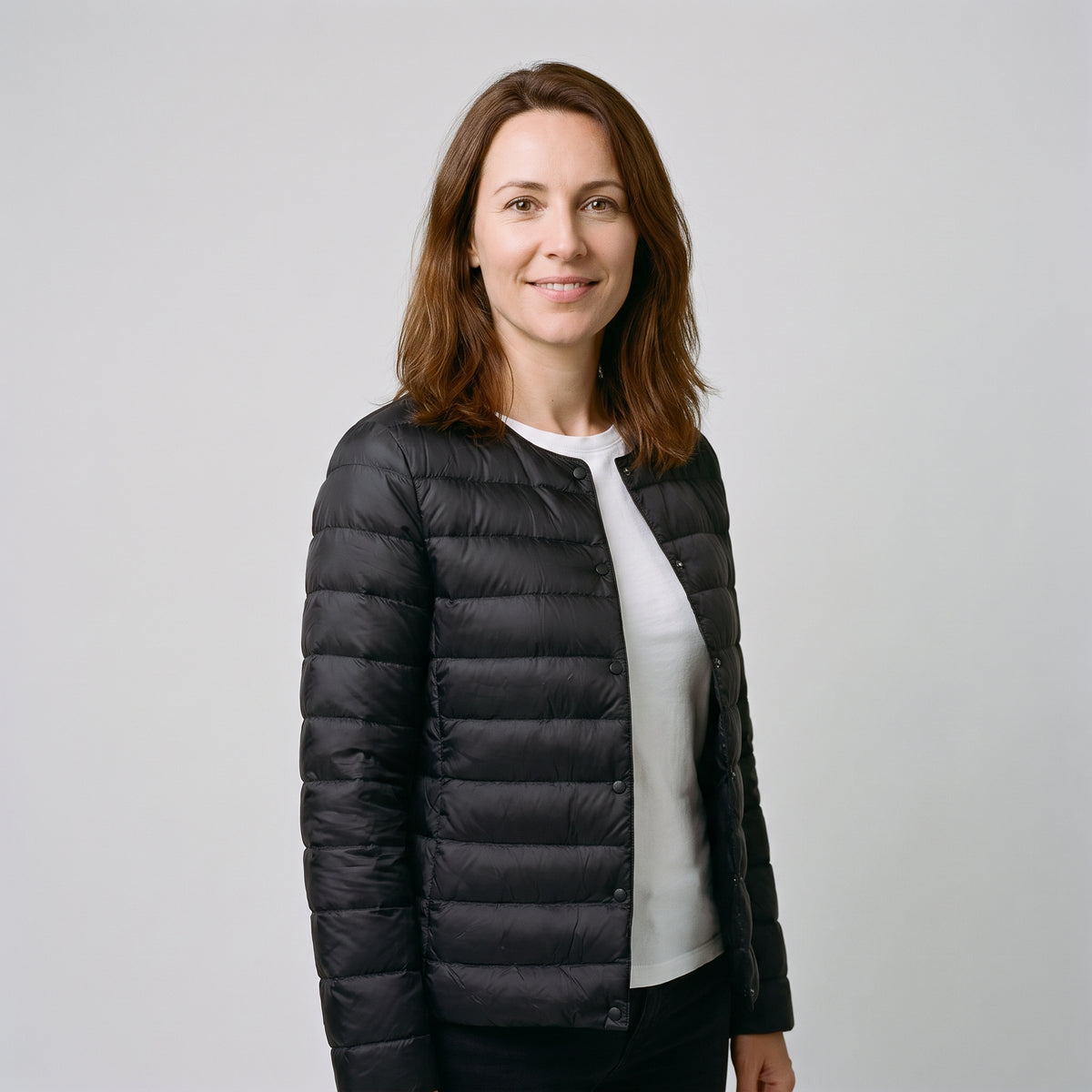 Women's Puffer Jacket in Black, three-quarter side view