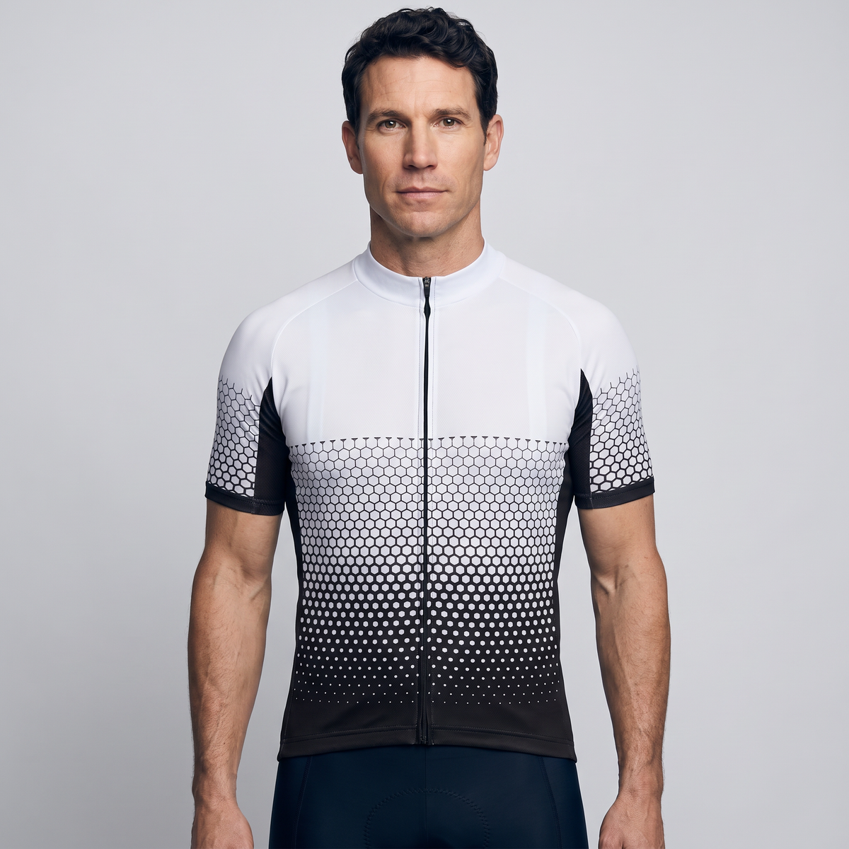 Men's cycling jersey in white and black hexagon fade, front view worn