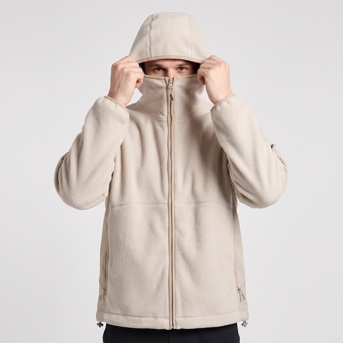 Chimney collar zipped over the mouth with the hood pulled down to meet it