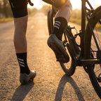 Cyclist riding at golden hour wearing the cycling socks