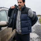 The down gilet worn over a fleece with a waterproof shell going on over the top