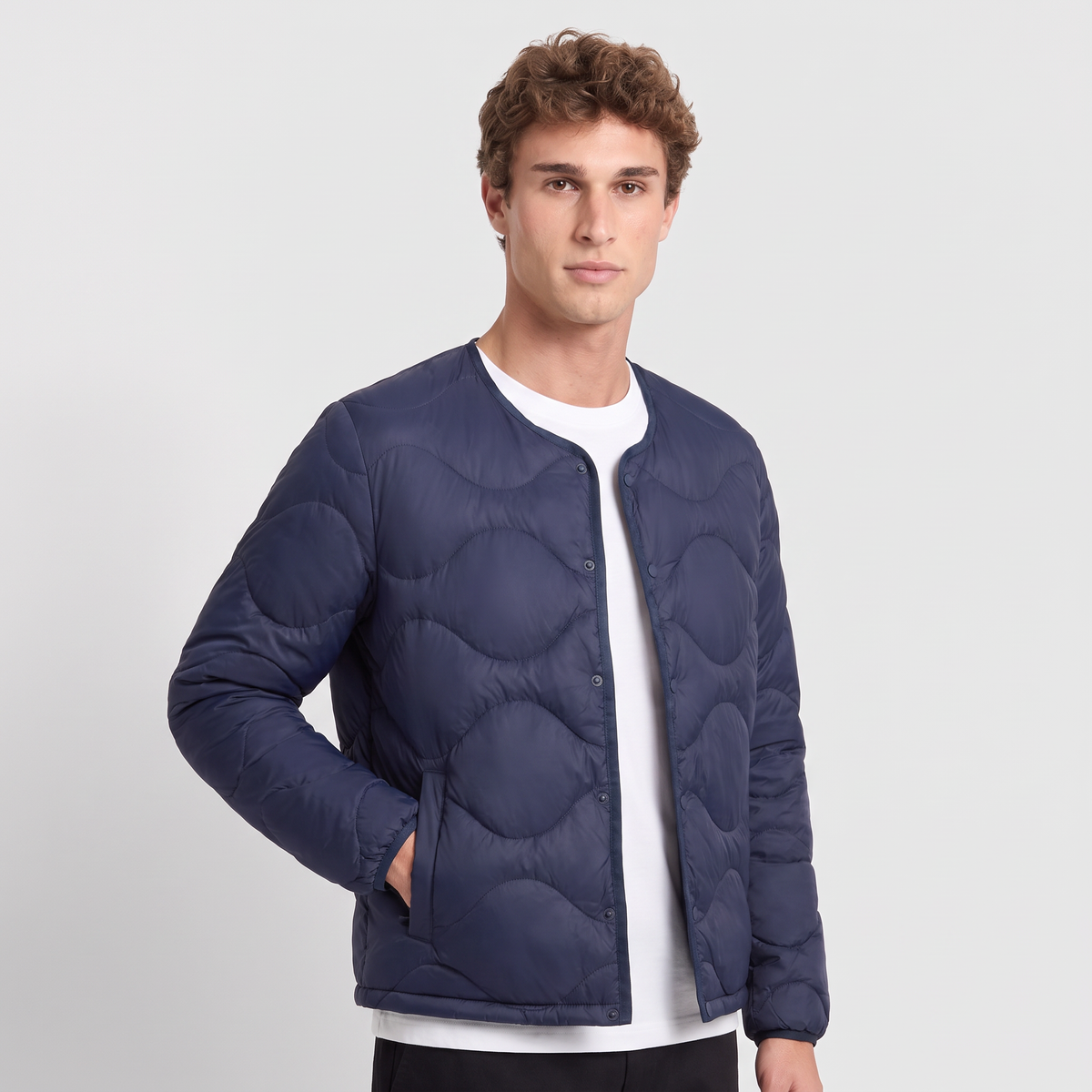Terrabound Men's Puffer Jacket in Navy, three-quarter view with hand in welt pocket