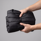 Jacket scrunched into a small packed bundle showing packability