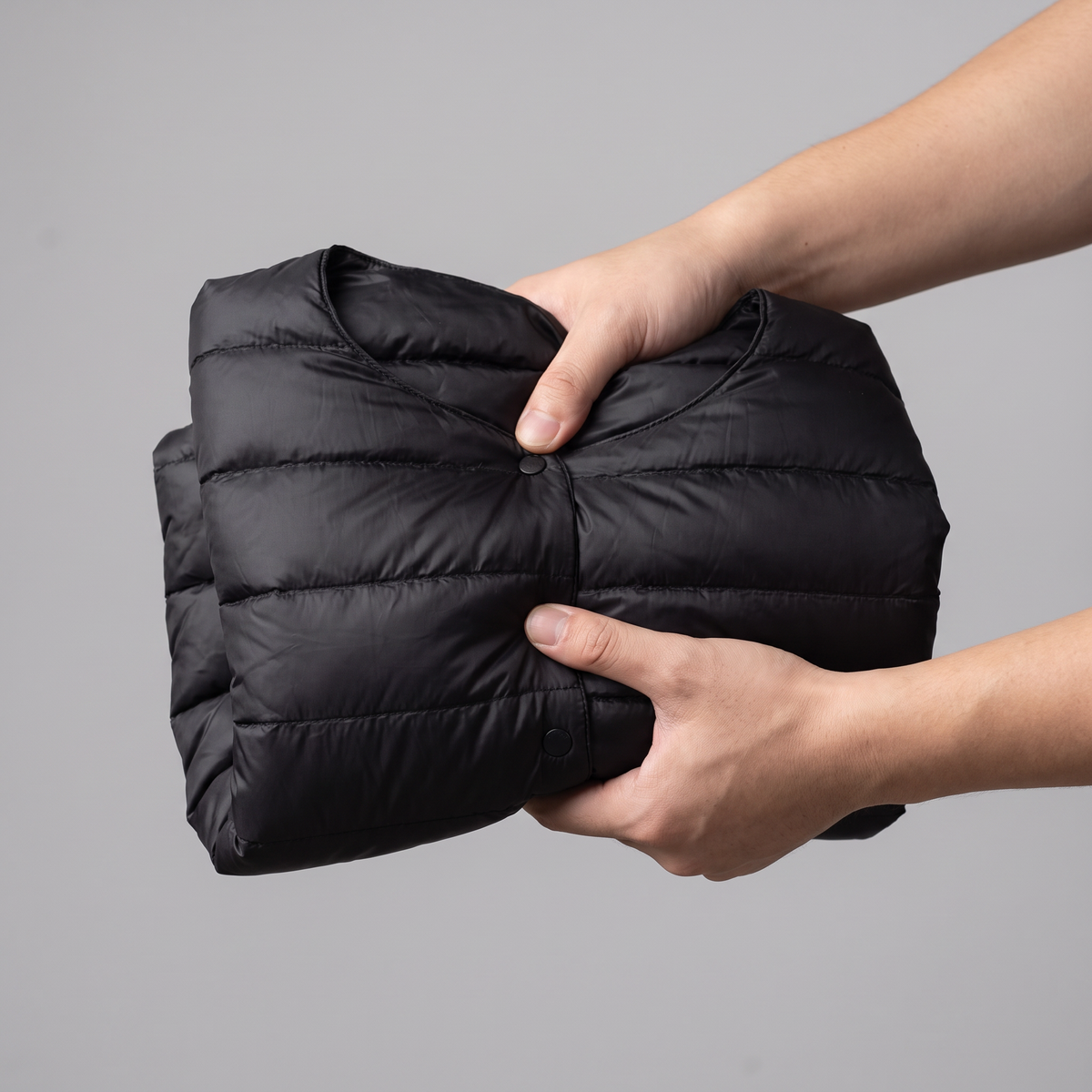 Jacket scrunched into a small packed bundle showing packability
