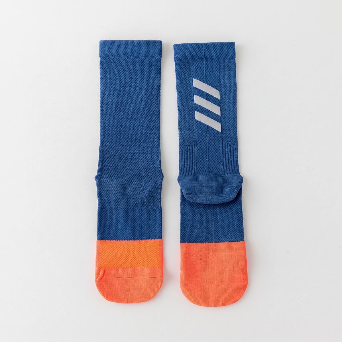 Cycling socks in Reflective Denim Blue, blue leg with an orange foot