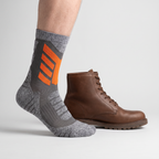 Crew height shown on the leg beside a walking boot, cuff sitting at mid-calf