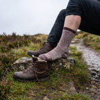 Walker on a hill path wearing the merino wool socks