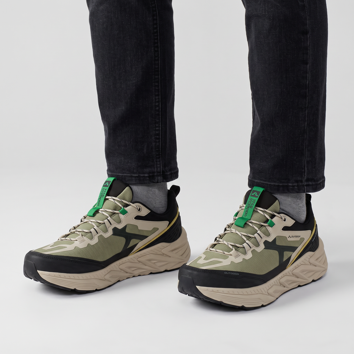 Terrabound Men's Trail Shoes in Olive worn with dark jeans, front view from the knee down
