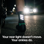 Reflective bars on the back of the sock cuff flaring under headlights from behind at night