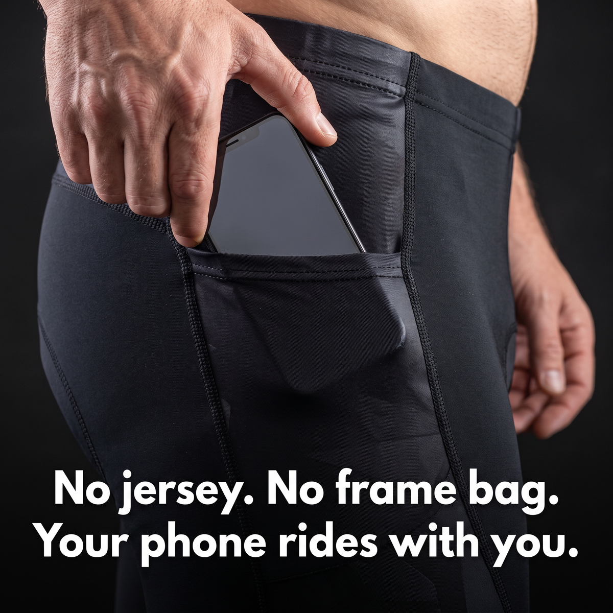 Hand sliding a phone into the open hip pocket of the cycling shorts